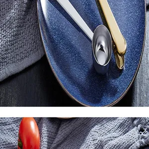 Stainless steel coffee scoop and bag sealing clip detail shot, durable kitchen measuring tool.