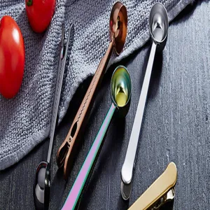 Stainless steel coffee scoop with bag sealing clip detail view, durable kitchen measuring tool.