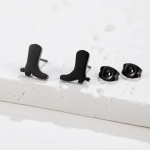 Close-up detail of stylish black stainless steel cowboy boot stud earrings with matching backs.