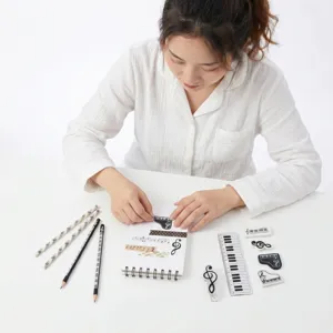 Detailed shot of music theme stationery set, featuring piano keys notebook and cute erasers.