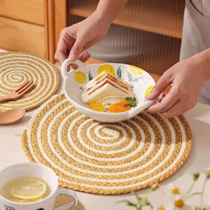Handmade woven round placemat detail, natural braided cotton rope coaster, heat resistant.