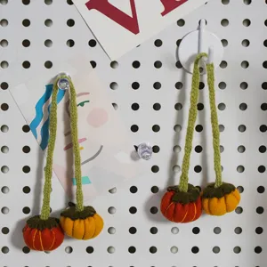 Halloween knitted pumpkin hanging decorations handmade festive napkin rings DIY supplies.