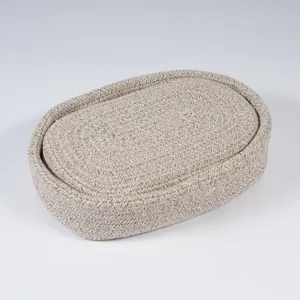 Woven cotton rope storage basket detail view with lid, featuring durable textured design.