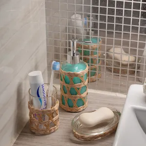 Handmade natural rattan wrapped glass bathroom set including soap dispenser and toothbrush cup.