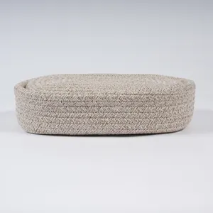 Detailed view of the beige woven cotton rope storage basket texture and fine craftsmanship.