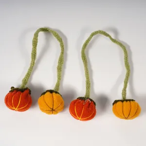 Halloween felt pumpkin napkin rings, handmade knitted vine decorative table accessories.