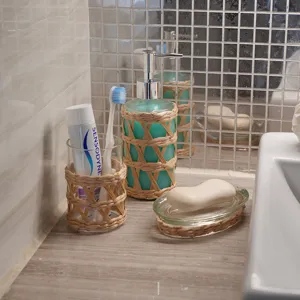 Handcrafted straw woven glass bathroom accessory set, pump dispenser, soap dish, and cup.
