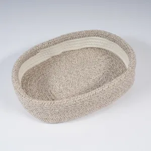 Close-up detail of the woven cotton storage basket showing its neat texture and sturdy build.