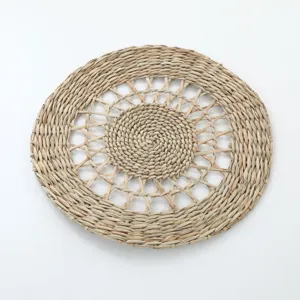 Natural woven seagrass placemat handmade round straw pet bird chewing toy mat for home decor.