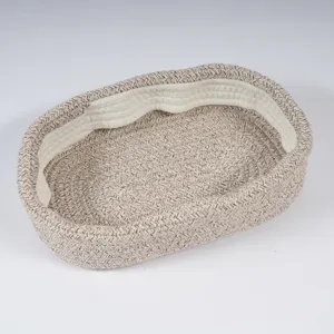Oval cotton rope woven storage basket, brown and white textured home organization basket.