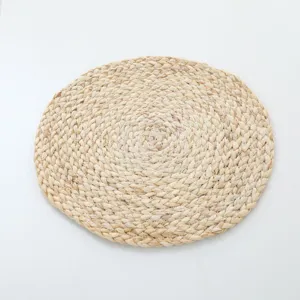 Detailed close-up view of the natural hand-woven straw mat texture and tight braiding.