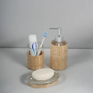 Natural woven glass bathroom accessory set, includes soap dispenser, tumbler and dish.