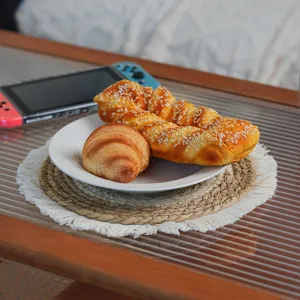 Detailed view of the woven placemat with fringe edge, natural straw texture for heat insulation