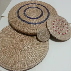 Handmade woven straw meditation mat detail, natural plant fiber round futon for yoga and home decor.