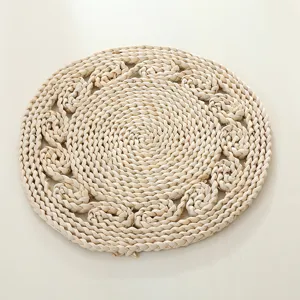 Round braided corn husk placemat detail showing natural texture and woven pattern craftsmanship.