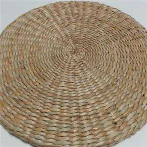 Detailed close-up shot of hand-woven natural straw meditation mat showing delicate texture.