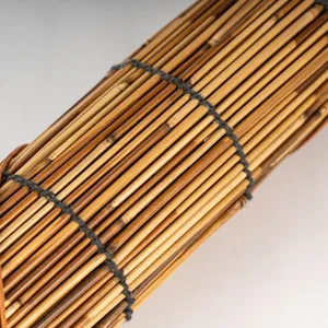 Detail view of natural reed curtain texture, woven roller blind for outdoor shade and decor.
