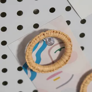 Close-up detail of hand-woven rattan napkin ring showing natural texture and delicate craftsmanship.