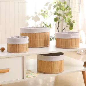 Natural pastoral style bamboo woven storage basket with cloth lining for home organization.