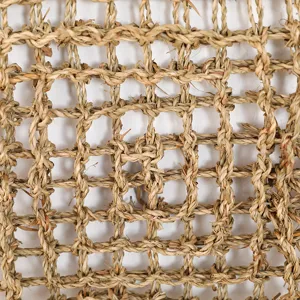 Close-up detail of natural seagrass woven pet mat grid texture surface for reptiles.