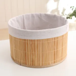 Close-up detail of natural hand-woven bamboo storage basket with soft linen lining.