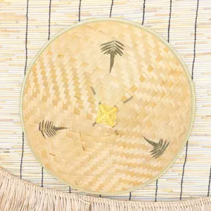 Handmade bamboo woven lampshade featuring natural leaf decor and traditional cone shape for home.