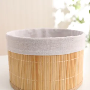 Natural pastoral bamboo storage basket detail, round woven container with fabric liner for home.
