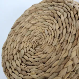 Detailed view of hand-woven straw storage basket showcasing natural texture and spiral craft.