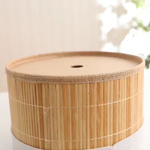 Handmade natural bamboo woven storage bucket detail, showing fine texture and lid with hole.