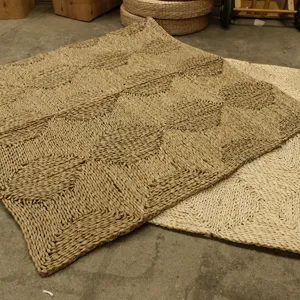 Natural corn husk woven floor mat detail view, geometric textured handmade rug for room.
