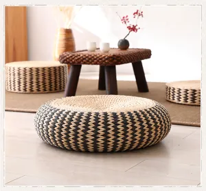 Close-up scene view of a Japanese style natural straw woven floor cushion on wooden floor.