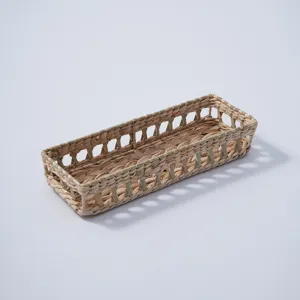 Handmade woven storage basket detail showing natural texture and hollow side design for desktop.