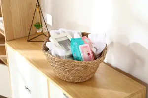 Handwoven straw storage basket for desktop organization, natural wicker home decor container.