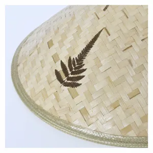 Handmade bamboo woven lampshade cone hat with natural leaf decor, rustic home decor crafts.