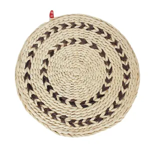 Round woven corn husk cushion for home bay window floor decor, natural textured straw seat mat.