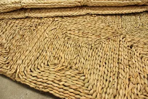 Handmade natural corn leaf woven floor mat and carpet detail shot for living room cozy decor