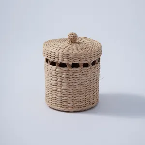 Close-up of a handmade woven storage basket with lid, perfect for desktop and home organization.