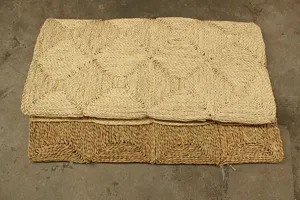 Close up view of natural corn leaf woven mat with geometric diamond pattern texture details.