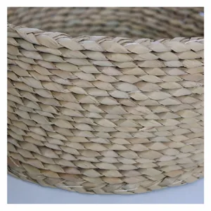 Handmade natural straw woven storage basket, rustic woven fruit basket for home organization.