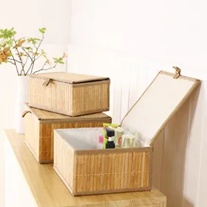 Handwoven bamboo storage basket detail, natural straw storage box with lid, home organizer.