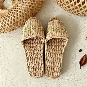 Detail shot of natural woven straw slippers showing exquisite plant fiber texture and craftsmanship.
