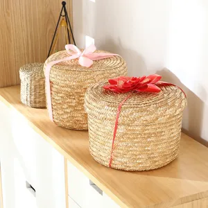 Handwoven straw storage basket with lid and ribbon, ideal desktop organizer and wedding gift box.