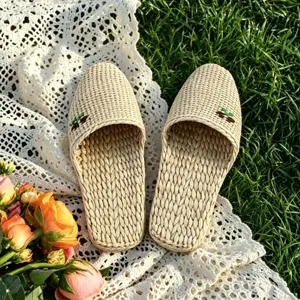 Handmade woven straw slippers detail view, featuring breathable indoor comfort footwear.