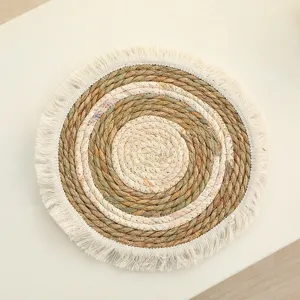 Handmade woven round placemat with fringe texture natural straw table mat for home decor detail view