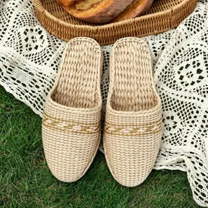 Handmade woven straw slippers detailed view, comfortable closed toe indoor casual footwear.
