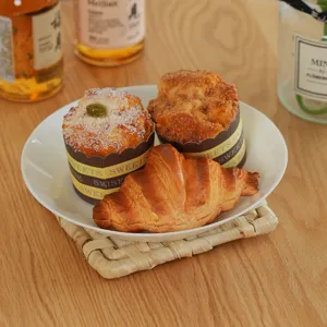 Detail view of woven table insulation mat and white ceramic plate with fresh bakery goods.