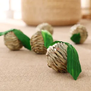 Close-up detail of natural woven grass pet chewing ball for small animals and hamsters.