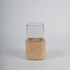 Handcrafted glass vase with natural rattan sleeve for chic home decor and hydroponic plants.
