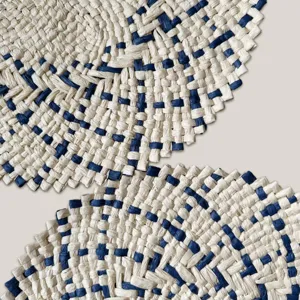 Close-up detail of blue and beige woven straw placemat showing natural texture and craftsmanship.