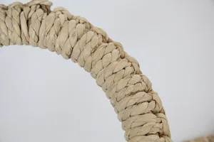 Handmade corn leaf woven pot mat detail, natural plant fiber texture for dining table decor.